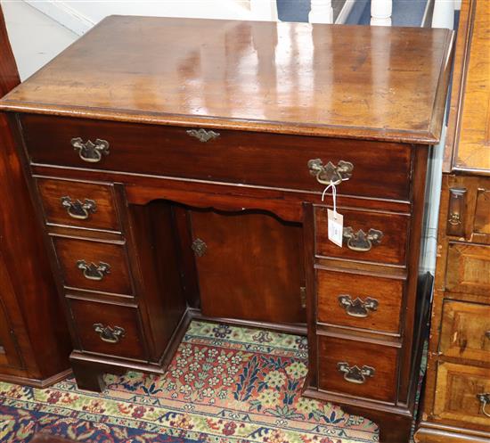 A George III style mahogany kneehole secretaire desk W.82cm